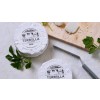Dwie paczki serka brie z naklejkami z logo