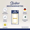 Obraz przedstawia zestaw naklejek designerskich z efektem złota. Wyróżnia cztery kluczowe cechy: łatwe do oznaczania, łatwo zdejmowalne, wyprodukowane w Niemczech i wykonane z ekologicznego papieru. Naklejki są zaprojektowane z białym tłem i złotymi obramowaniami.