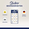 Obraz przedstawia arkusz naklejek z różnorodnymi wzorami biedronek w złotych i srebrnych efektach, opatrzony etykietą 'Design Sticker'. Wspomniano, że produkt jest wyprodukowany w Niemczech.
