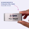 Obraz przedstawia 10 identyfikatorów z wykończeniem ze stali nierdzewnej, na których widnieje logo 'Avery' i imię 'Paul Meyer'. Identyfikatory są ukazane w dłoni osoby.
